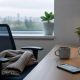 An empty office chair beside a quiet desk on a sick day