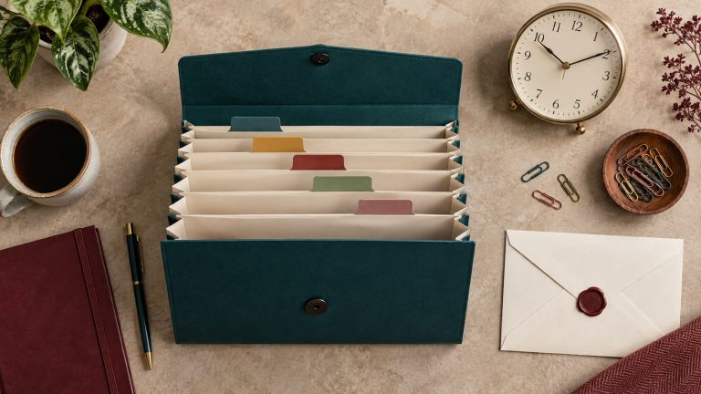 Accordion folder with blank dividers, a clock and an envelope arranged as an application workflow