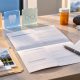 Organized Alberta Adult Health Benefit application desk with abstract prescription, glasses and dental-care symbols